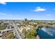 Aerial view showcasing the city skyline and a large lake, alongside a bustling street lined with trees at 400 E Colonial Dr # 1504, Orlando, FL 32803