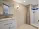 Bathroom vanity and sink with walk-in shower featuring decorative tile and a built-in shelf at 400 E Colonial Dr # 1504, Orlando, FL 32803
