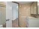 Bathroom vanity and sink, leading to a separate room with herringbone floors and a tiled shower space at 400 E Colonial Dr # 1504, Orlando, FL 32803