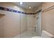 Walk-in shower featuring tile and a glass partition, complemented by a shower head with a handheld sprayer at 400 E Colonial Dr # 1504, Orlando, FL 32803
