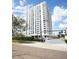 Exterior of a condominium building with white balconies against a blue sky with puffy white clouds at 400 E Colonial Dr # 1504, Orlando, FL 32803