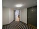 Condo hallway featuring black and white honeycomb patterned flooring, and gray trim and doors at 400 E Colonial Dr # 1504, Orlando, FL 32803