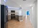 Modern kitchen featuring stainless steel appliances, light gray cabinets, and herringbone wood flooring at 400 E Colonial Dr # 1504, Orlando, FL 32803