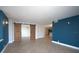 Spacious living room with blue accent wall and wood-look floors and sliding barn doors at 400 E Colonial Dr # 1504, Orlando, FL 32803