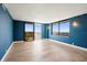 Bright living room with stylish blue walls, herringbone floors, and sliding doors leading to a balcony at 400 E Colonial Dr # 1504, Orlando, FL 32803