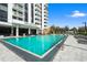 Outdoor pool offering a clear view of Park Lake Towers and poolside lounge chairs for relaxation at 400 E Colonial Dr # 1504, Orlando, FL 32803