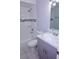 This bathroom features tiled walls, a tub, toilet, and a gray vanity at 4235 W Vista Ct, Kissimmee, FL 34746
