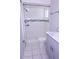 This renovated bathroom features tiled walls, a shower, toilet, and a gray vanity at 4235 W Vista Ct, Kissimmee, FL 34746