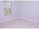 Bedroom with tiled flooring, light-colored walls, and natural light from the window at 4235 W Vista Ct, Kissimmee, FL 34746