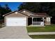 Charming single-story home with a well-maintained lawn, covered porch, and attached two-car garage at 4235 W Vista Ct, Kissimmee, FL 34746