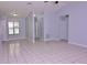 Open-concept living room featuring neutral walls, tile flooring, and recessed lighting at 4235 W Vista Ct, Kissimmee, FL 34746