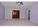 Spacious living room featuring tile flooring, a ceiling fan, and French doors at 4235 W Vista Ct, Kissimmee, FL 34746