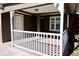 Charming covered porch with white railing, offering a cozy outdoor space at 4235 W Vista Ct, Kissimmee, FL 34746