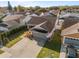 Aerial view of a single-Gathering home in a residential neighborhood, featuring a two-car garage and manicured landscaping at 4614 Osceola Point Trl Trl, Kissimmee, FL 34746