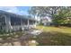 Enjoy outdoor relaxation on the patio with lounge chairs, surrounded by a spacious backyard and lush greenery at 4884 Meadow Dr, St Cloud, FL 34772