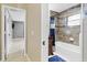 A view down the hall to an updated bathroom with tub and shower at 4884 Meadow Dr, St Cloud, FL 34772