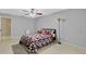 Bedroom with tile flooring, gray walls, ceiling fan, and warm natural light at 4884 Meadow Dr, St Cloud, FL 34772