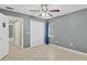 The bedroom has tile flooring, gray walls, ceiling fan, and natural light at 4884 Meadow Dr, St Cloud, FL 34772