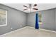 Empty bedroom showcasing tile flooring, gray walls, and natural light at 4884 Meadow Dr, St Cloud, FL 34772