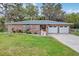 Charming brick home featuring a well-maintained lawn, double garage, and inviting facade at 4884 Meadow Dr, St Cloud, FL 34772