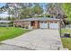 Charming brick home featuring a well-maintained lawn, double garage, and inviting facade at 4884 Meadow Dr, St Cloud, FL 34772