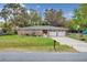 Charming brick home featuring a well-maintained lawn, double garage, and inviting facade at 4884 Meadow Dr, St Cloud, FL 34772