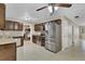 Modern kitchen with stainless steel appliances and tiled floors, adjacent laundry room at 4884 Meadow Dr, St Cloud, FL 34772