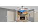 Living room features a stone fireplace with mounted TV and tile flooring at 4884 Meadow Dr, St Cloud, FL 34772