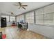 Spacious sunroom with tile floors, multiple windows, ceiling fans, and a workspace at 4884 Meadow Dr, St Cloud, FL 34772