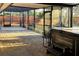 View of a covered patio with brick floors, a hot tub, and a screened-in porch area at 5019 Saint Germain Ave, Belle Isle, FL 32812