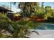 Well-maintained backyard featuring a pool, privacy fence, and tropical plants for a serene retreat at 5019 Saint Germain Ave, Orlando, FL 32812