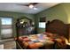 Cozy bedroom featuring hardwood floors, a comfortable queen-sized bed, dresser, and bright windows at 5019 Saint Germain Ave, Orlando, FL 32812