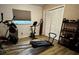 Home exercise room with a variety of equipment and a window for natural light at 5019 Saint Germain Ave, Orlando, FL 32812