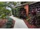 Inviting front yard showcasing the home's landscape design with vibrant plants and a paved walkway at 5019 Saint Germain Ave, Orlando, FL 32812