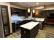Well-appointed kitchen boasts sleek, dark cabinetry, stainless steel appliances, and a functional island at 5019 Saint Germain Ave, Orlando, FL 32812