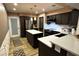 A modern kitchen features stainless steel appliances, an island, and sleek dark cabinetry at 5019 Saint Germain Ave, Orlando, FL 32812