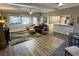 Comfortable living room with wood floors, stylish furniture, and a sunny window overlooking the landscaped yard at 5019 Saint Germain Ave, Orlando, FL 32812