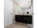 Bathroom with granite countertops, a double sink vanity and a full-sized mirror at 521 Pacito Way, St Cloud, FL 34769