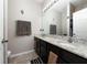 Bathroom featuring a double sink vanity with granite countertops and a large mirror at 521 Pacito Way, St Cloud, FL 34769