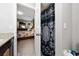 View of bathroom with granite countertops and a peek into the main bedroom and shower at 521 Pacito Way, St Cloud, FL 34769