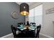 Cozy dining area featuring a modern light fixture and decorative wall art at 521 Pacito Way, St Cloud, FL 34769