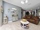 Inviting living room featuring tile floors, cozy couches, decorative accents and gray walls at 521 Pacito Way, St Cloud, FL 34769