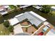 Waterfront property with boat dock, featuring meticulous landscaping, metal roof, and circular driveway at 534 Minnow Ct, Kenansville, FL 34739