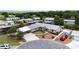 Aerial view of home with double carport, lush landscaping and waterfront access at 534 Minnow Ct, Kenansville, FL 34739