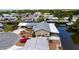 Aerial view of home with carport, patio and canal with dock at 534 Minnow Ct, Kenansville, FL 34739