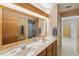 Bathroom featuring double sinks and vanity with a large mirror and tiled walls at 534 Minnow Ct, Kenansville, FL 34739
