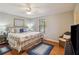 Serene bedroom with a king-size bed, hardwood floors, and a view of the outside at 534 Minnow Ct, Kenansville, FL 34739