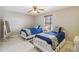 Bedroom features twin beds, neutral walls, tiled floor, and a ceiling fan at 534 Minnow Ct, Kenansville, FL 34739