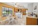 Open concept dining area with a round table, bar seating, and adjacent kitchen at 534 Minnow Ct, Kenansville, FL 34739