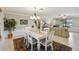 Bright dining area with a white table, chandelier, and adjacent living space at 534 Minnow Ct, Kenansville, FL 34739